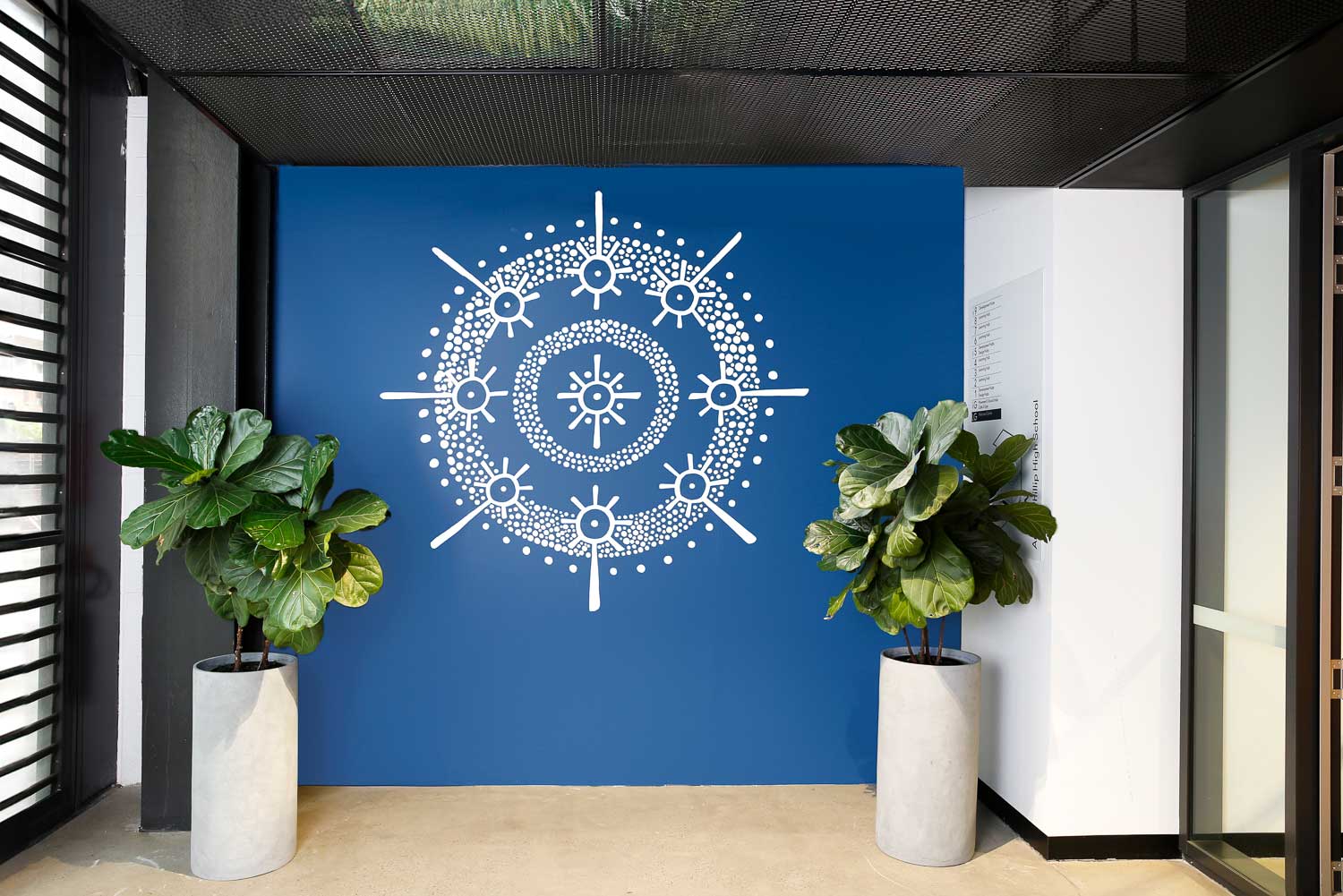 Aboriginal artwork by Chris Tobin white markmaking on blue wall