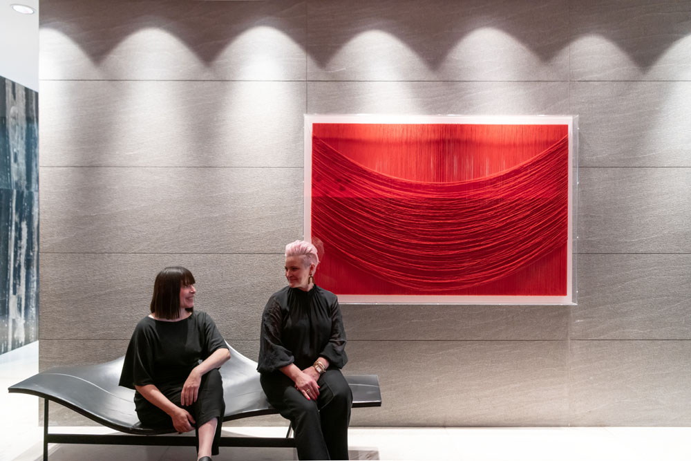 Curator Claire Field and Director Sophie Vander in The Star Sydney sitting under a red thread a Graziella Giordano