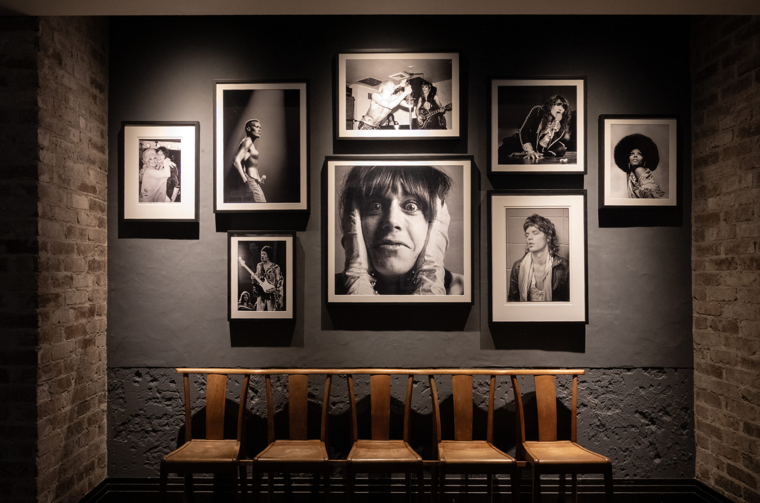 salon hang on a brick wall of black and white photographs of celebrities